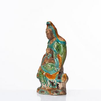 A green, turquoise, yellow and aubergine glazed figure of Guanyin, late Ming dynasty (1368-1644).