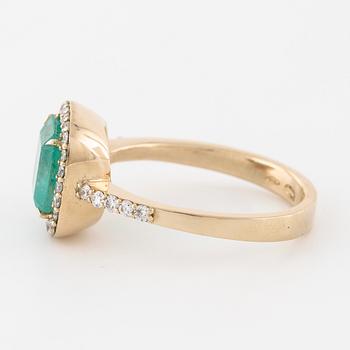 A emerald and brilliant cut diamond ring.