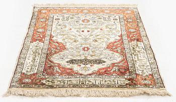 A silk and metal Hereke rug, c. 80 x 51 cm.