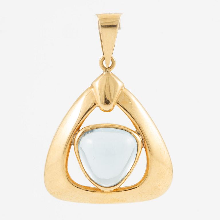 Pendant in 18K gold with a blue stone.