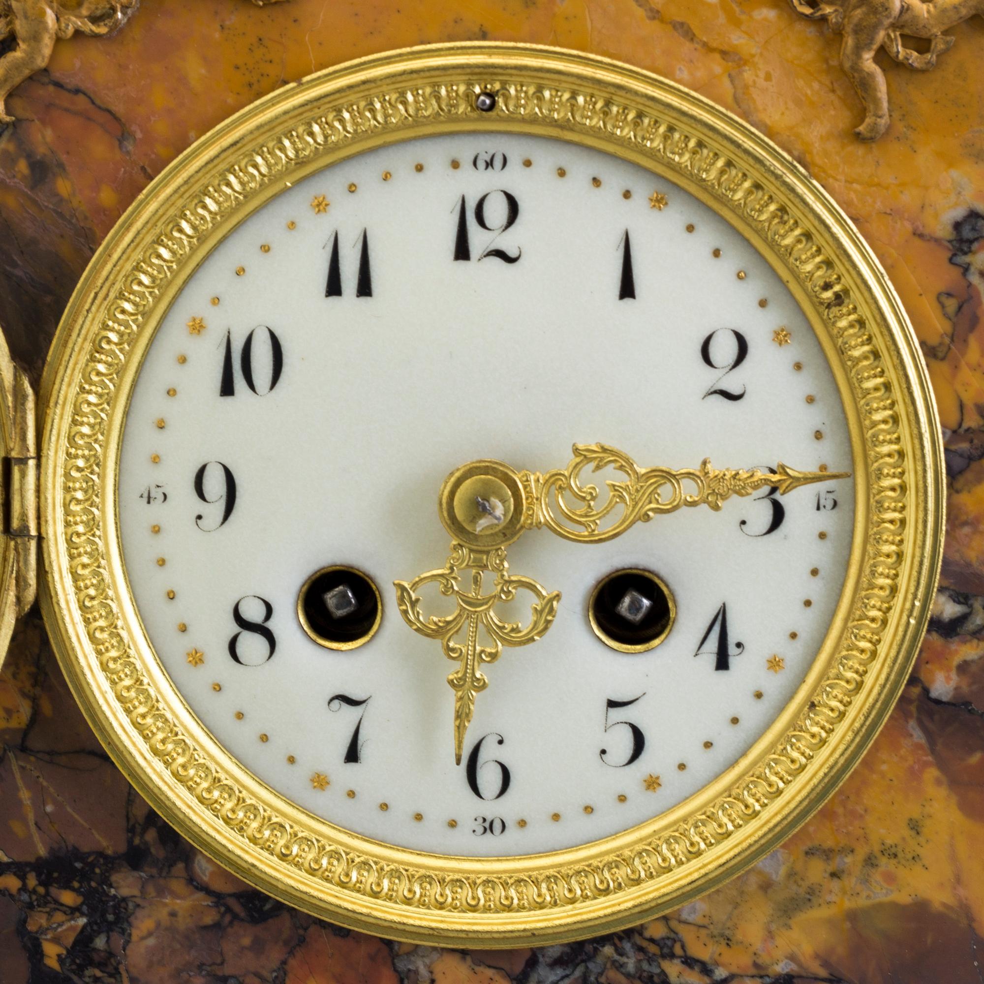 A turn of the century 1900 gilt brass and marble century mantle clock.
