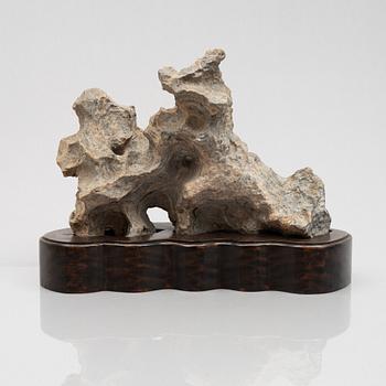 A Scholar's rock on hardwood stand, China, 20th century.