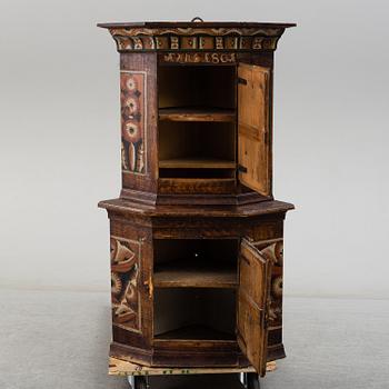 A 19th century corner cabinet.