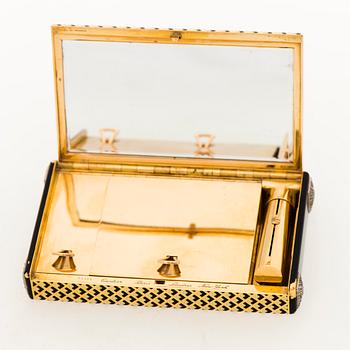 A Cartier Art Deco Vanity Case in 18K gold with enamel and baguette- and rose-cut diamonds. On the inside a mirror, two separate compartments with lid...