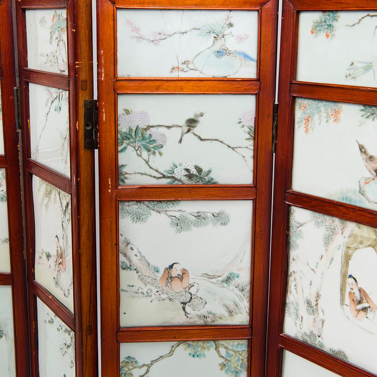 A Chinese folding screen with 48 porcelain tiles, late Qing dynasty, signed Ren Huanzhang, and dated 1881.