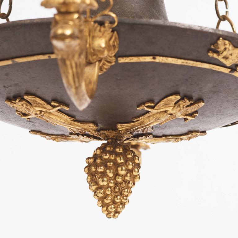 An ormolu and painted bronze four-light Empire chandelier, early 19th century.