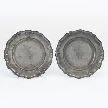 A pair of rococo pewter chargers, mid 18th Century.