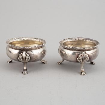 Two pairs of English 18th century silver salt-cellars, marked in London 1762 and 1769.