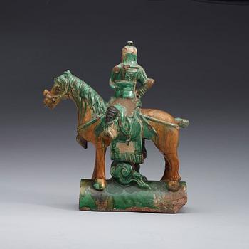 A green and brown glazed ridge tile figure of Guan Yu riding a horse, Ming dynasty  17th century.