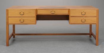 A Josef Frank walnut desk by Svensk Tenn, the front with five drawers, the backwith a bookshelf.