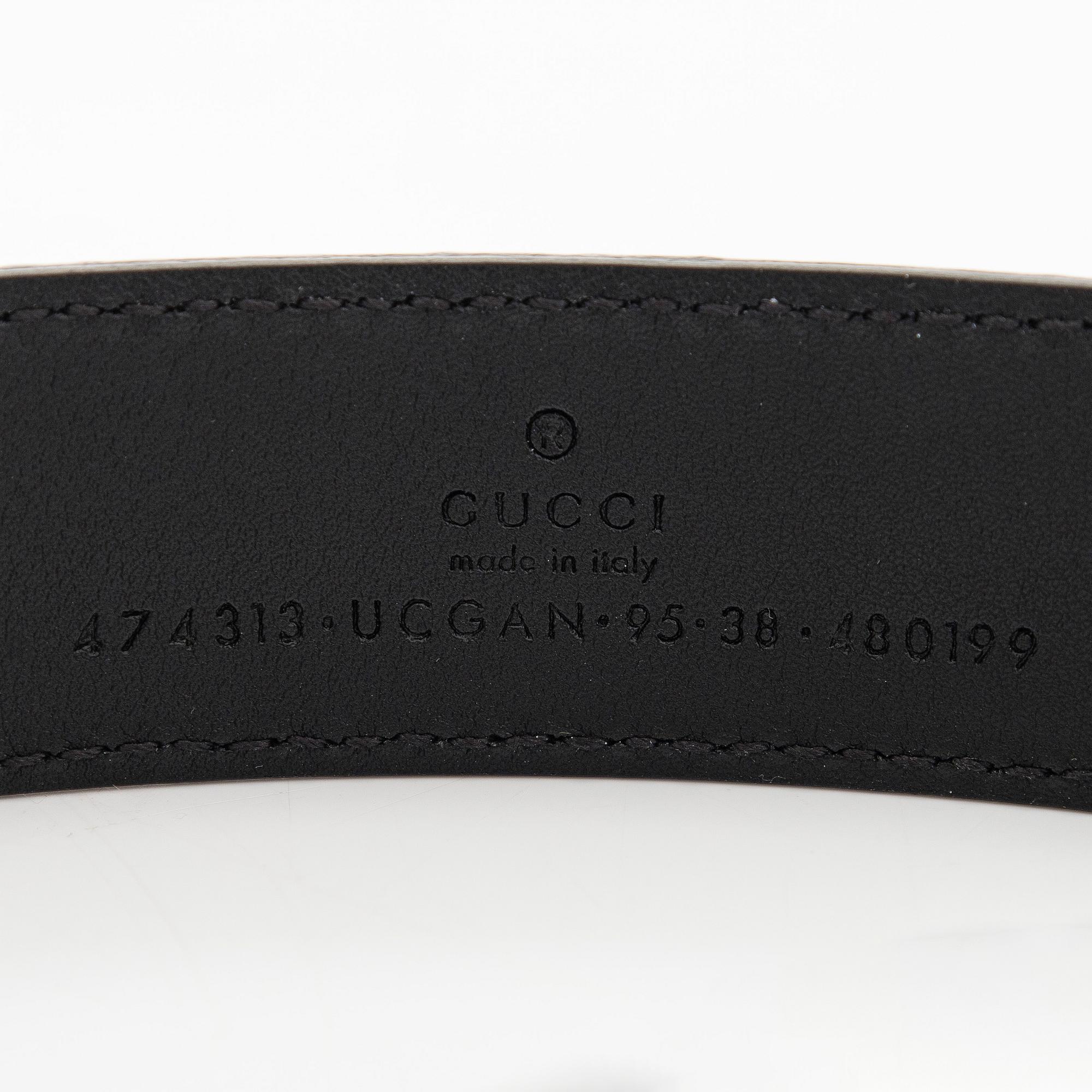 Gucci, an embossed leather belt and cardholder.
