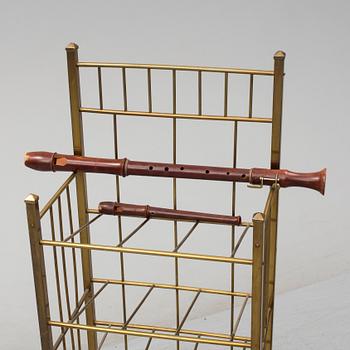 A brass shelf and two flutes, 20th century.