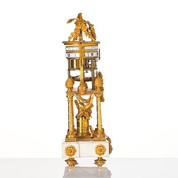 A Louis XVI marble and ormolu 'aux cercles tournants' portico mantel clock, late 18th century.