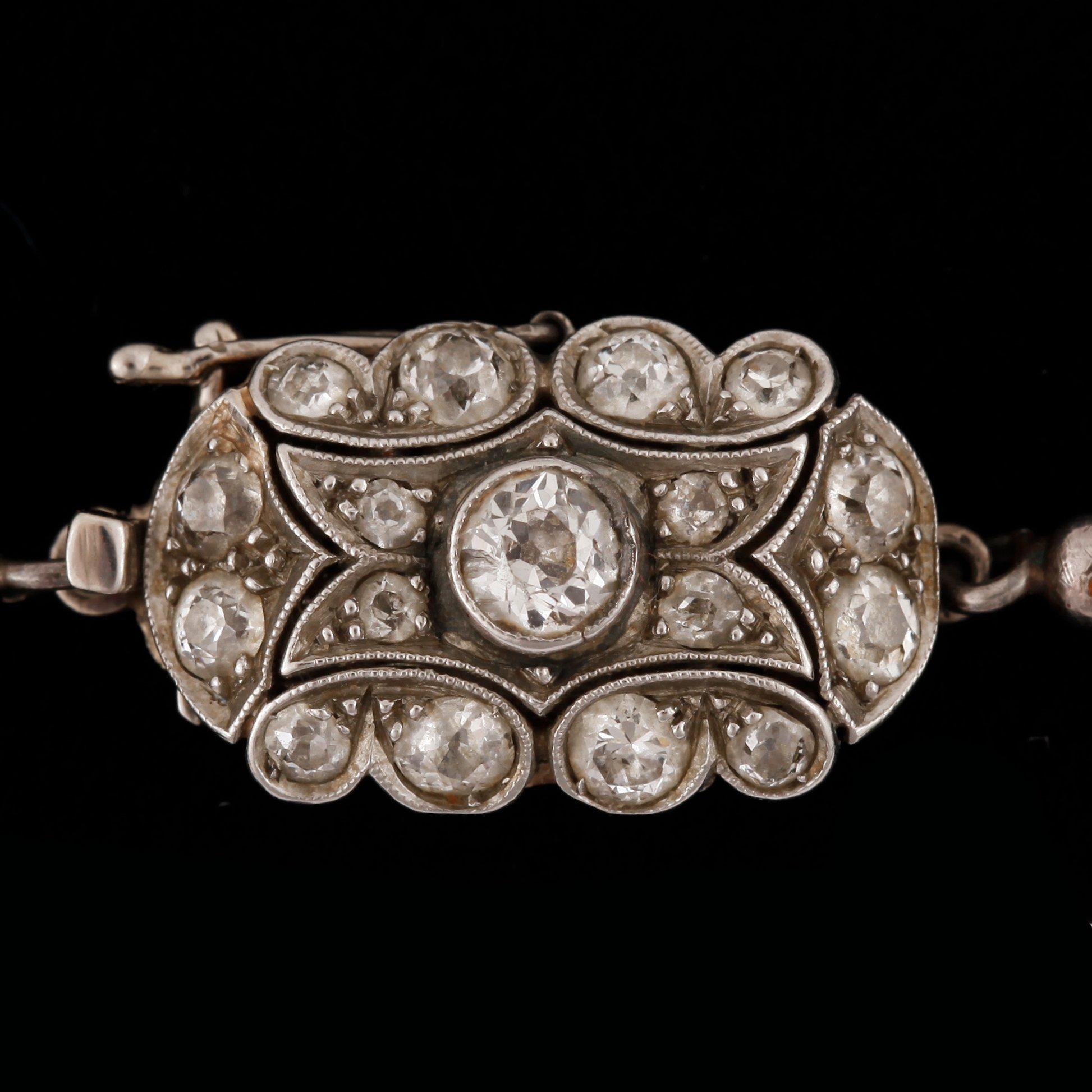 A cultivated saltwater pearl necklace. Circa 3.3-7.5 mm. Clasp with old cut diamonds, total gem weight circa 0.75 ct.