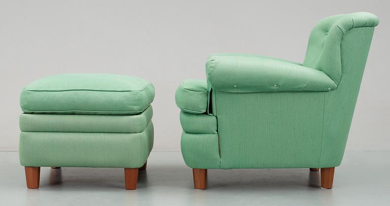 A Josef Frank armchair with ottoman, by Svenskt Tenn, model 568.