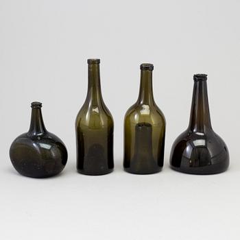 A set of four 18th/19th century hand blown glass bottles.