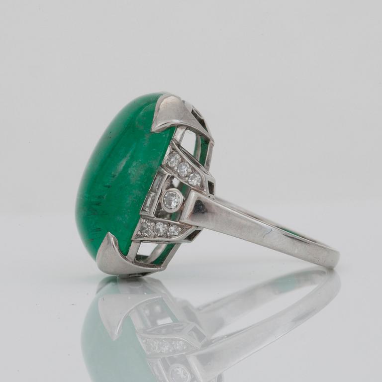 A circa 18.00 ct cabochon-cut emerald and diamond ring. Total carat weight of diamonds circa 0.30 ct.