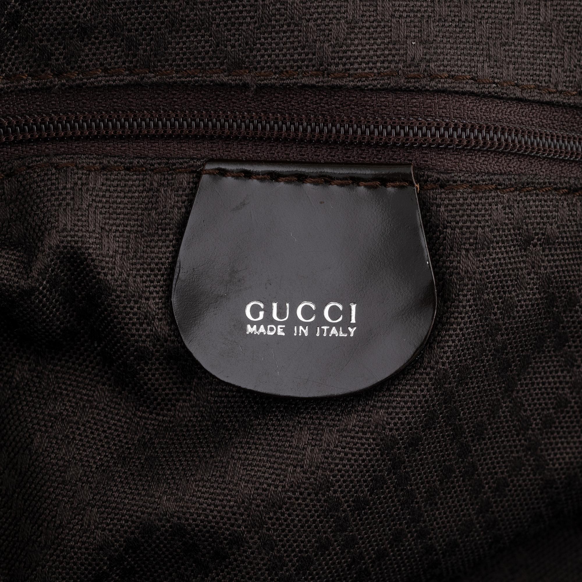 Gucci, a chocolate brown nylon handbag.