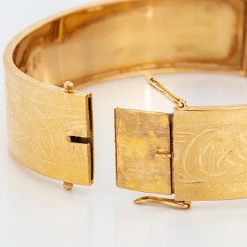 An 18K gold bangle.