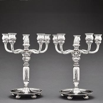 117. Georg Jensen, a pair of 830/1000 silver five light candelabra, Copenhagen 1920, design nr 200.