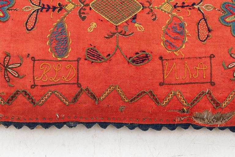 An embroidered carriage cushion, 100 x 50 cm, dated 1852.