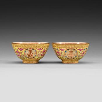 93. A pair of famille rose yellow ground cups, Qing dynasty, Guangxu six-character mark and of the period  (1875-1908).