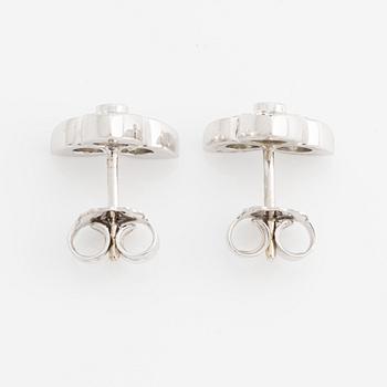 A pair of 18K white gold earrings with round brilliant-cut diamonds.