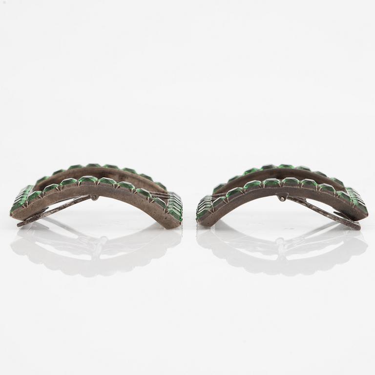 A pair of shoe buckles in white metal with green paste stones.