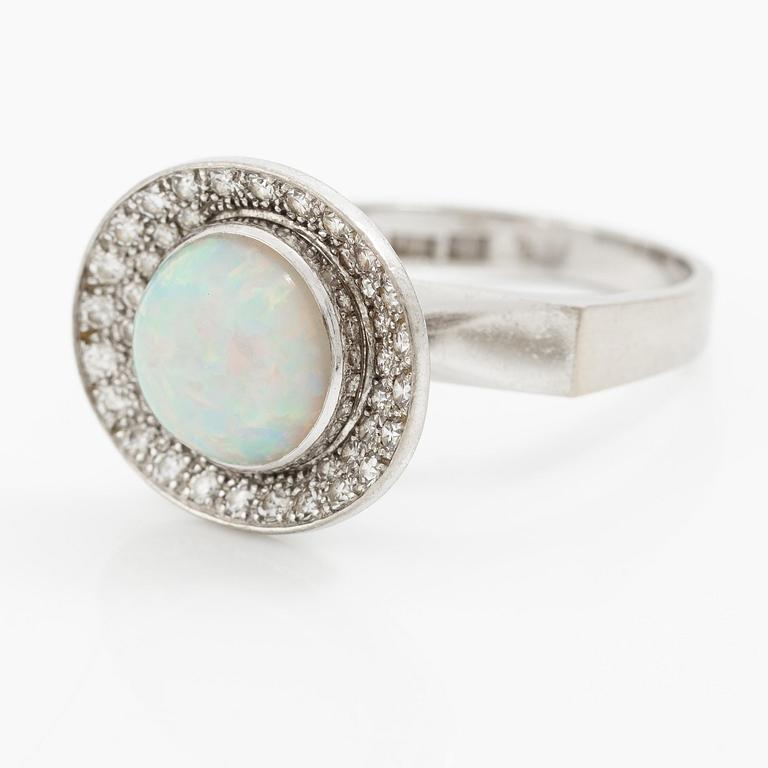 A ring 18K white gold set with an opal and eight-cut diamonds. CF Carlman, Stockholm 1973.