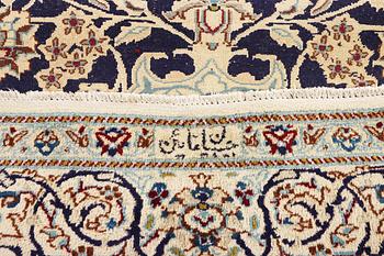 A Nain carpet, part silk, c. 338 x 244 cm.