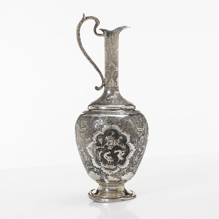A Persian silver pitcher with five stemmed cups and a beaker, first part of the 1900s.