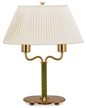 A Josef Frank brass and green leather table lamp by Svenskt Tenn.