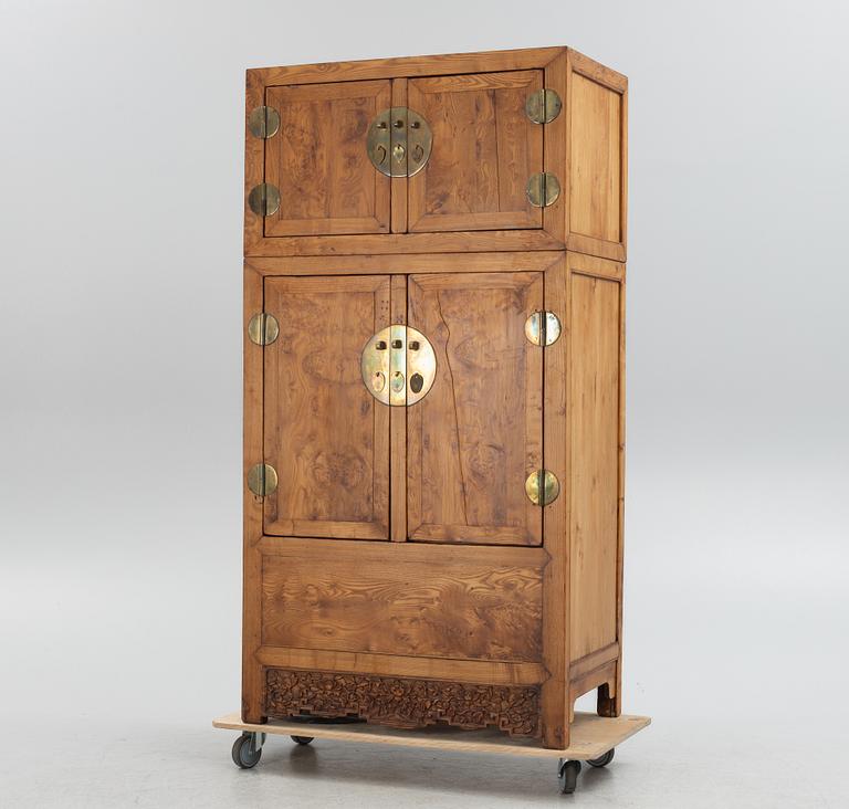 A Chinese hardwood two-part cabinet, 20th century.