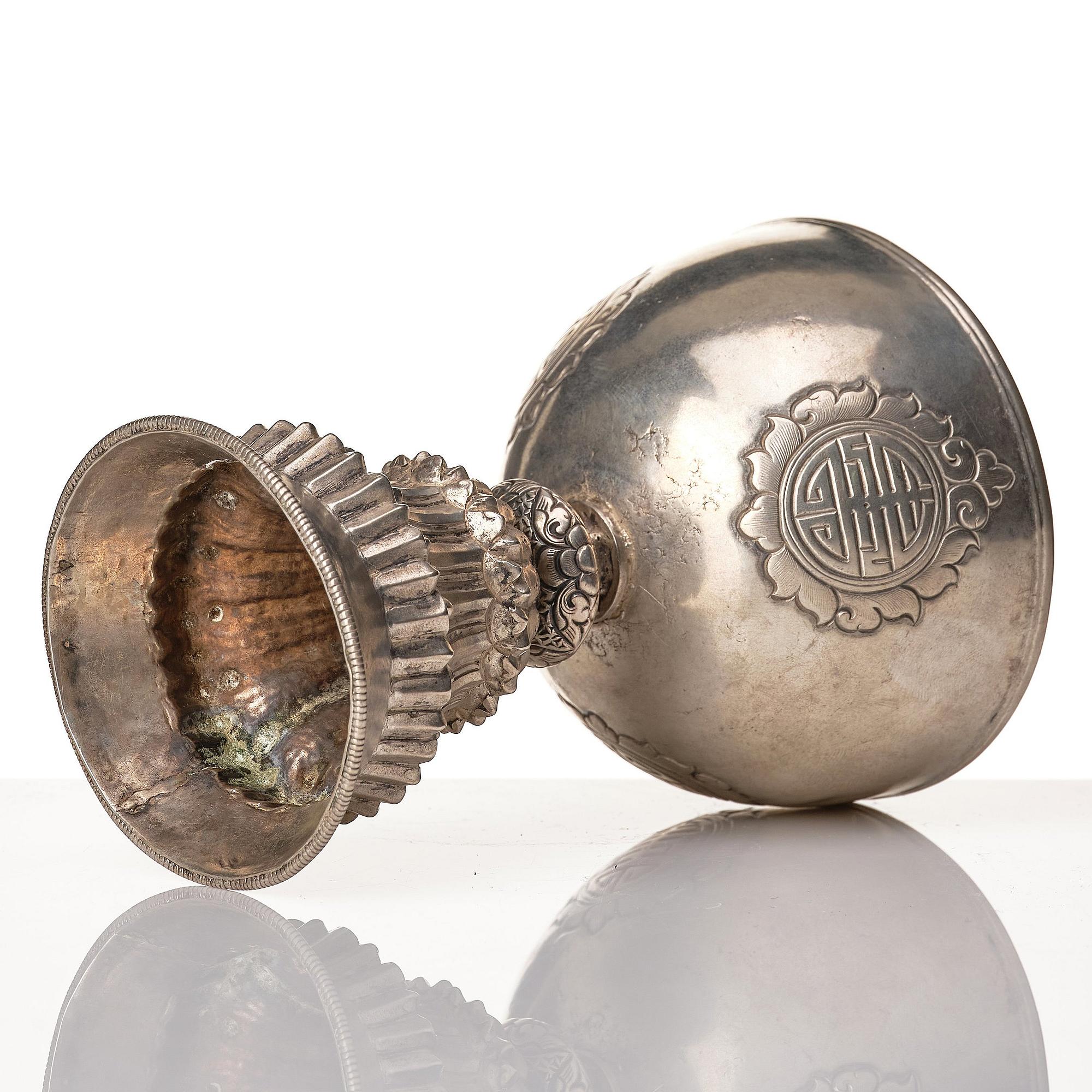 A Tibetan butter lamp, silvered copper, 20th century.