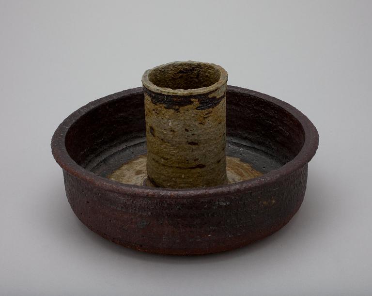 A CERAMIC CANDLESTICK.