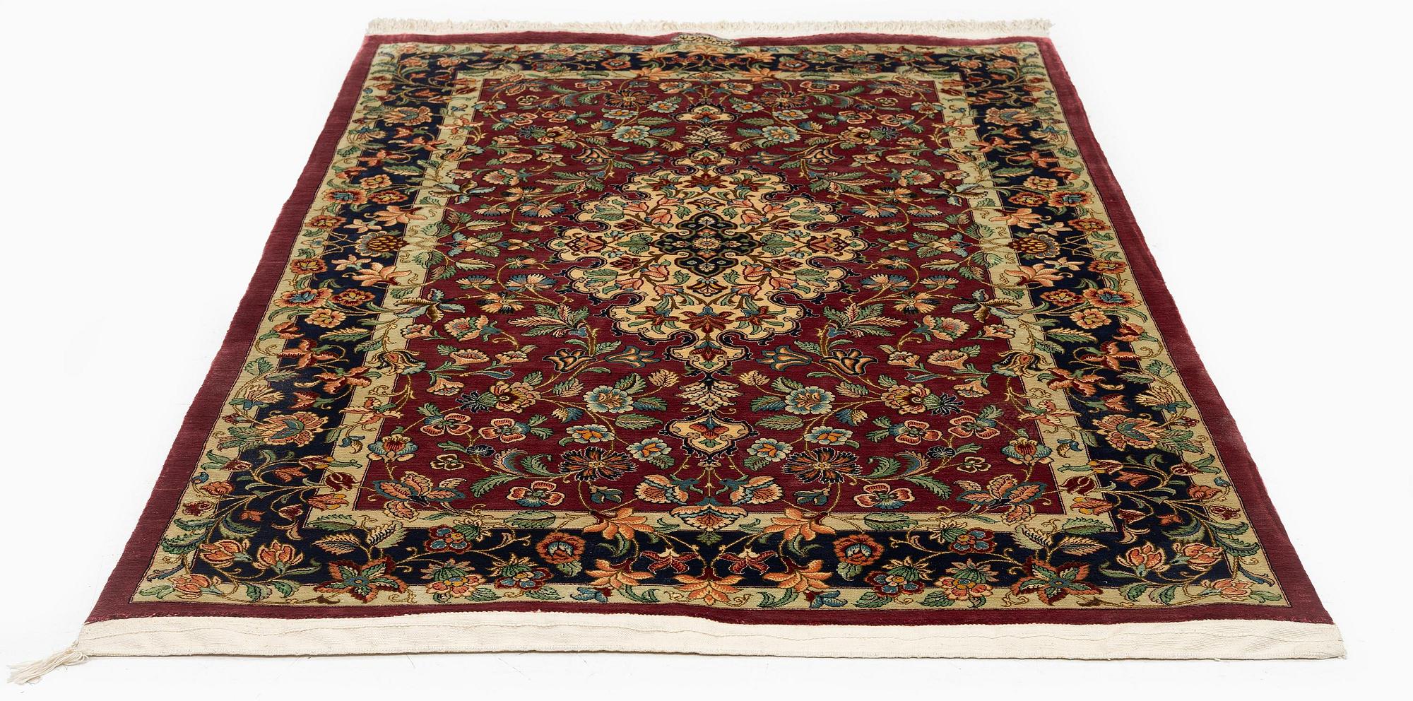 A silk Qum rug, Central Iran, signed, c. 170 x 101 cm.