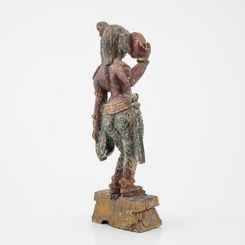 A wooden sculpture of a deity, Indian, 20th Century.