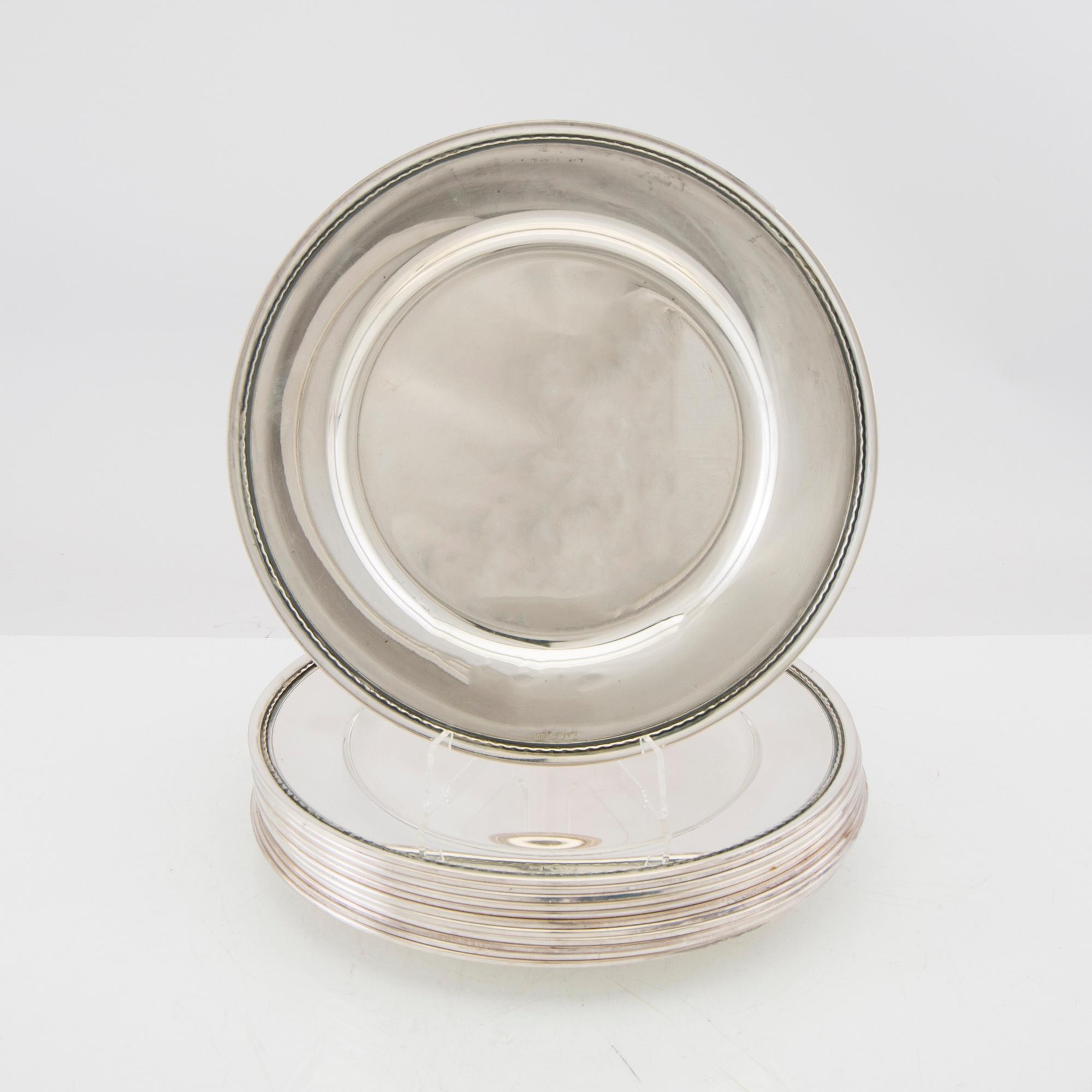 A set of 12 silver plates mark of GAB Stockholm 1963, total weight 6000 grams.