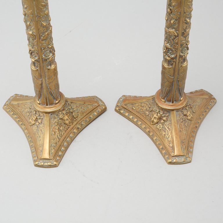A pair of brass candlesticks from Elkingtons in Birmingham, 19th century.