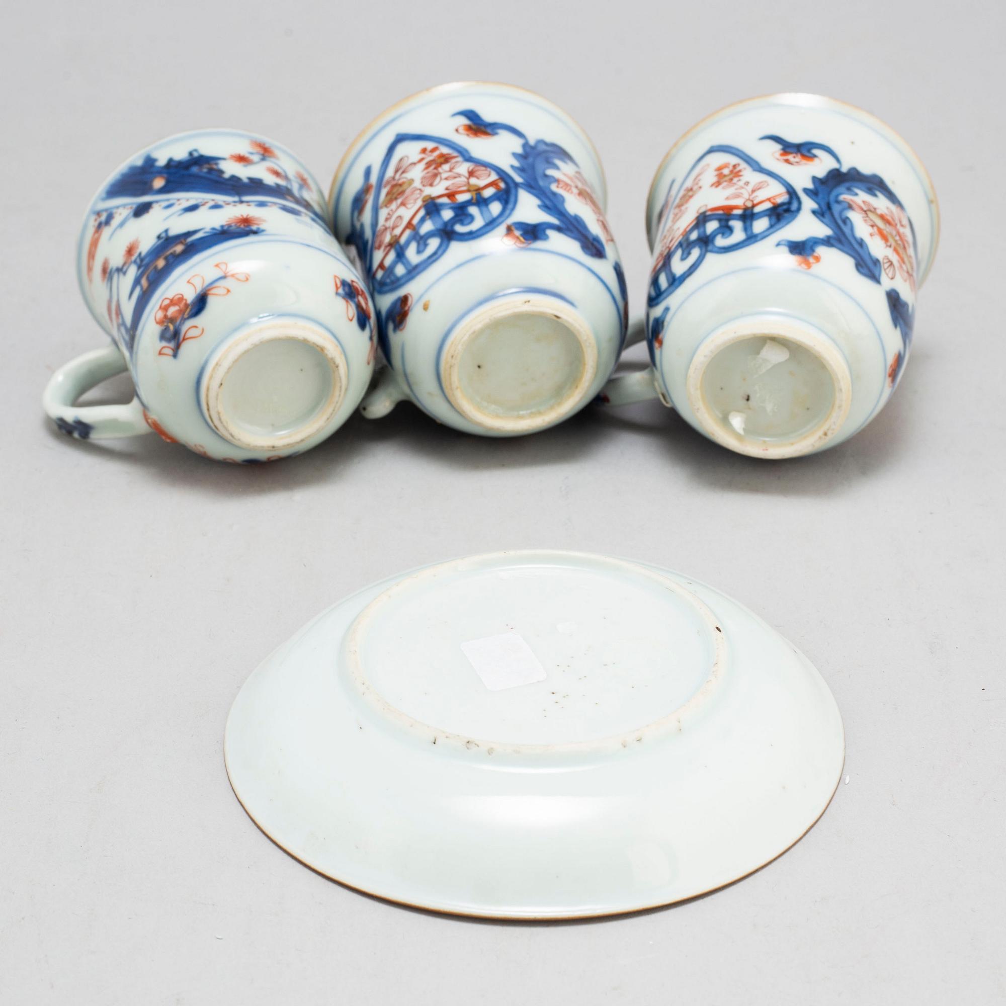 A pair of imari cups and a cup and saucer, Qing dynasty, 18th century.