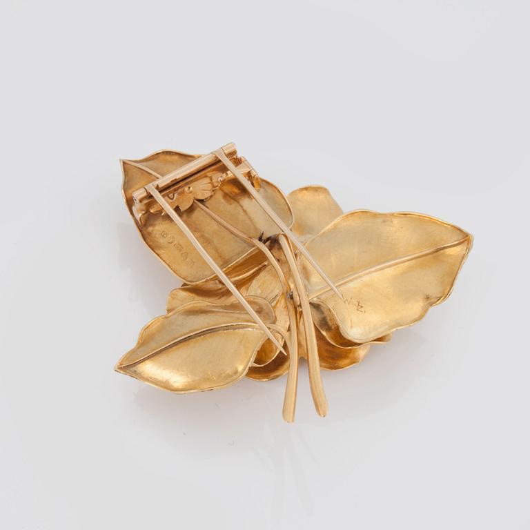 BROSCH med en cabochonslipad smaragd samt diamanter.