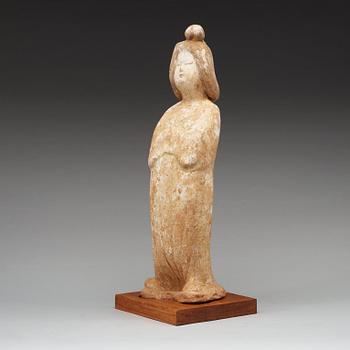 A pottery figure of a elegant female courtier, Tang dynasty (618-907).