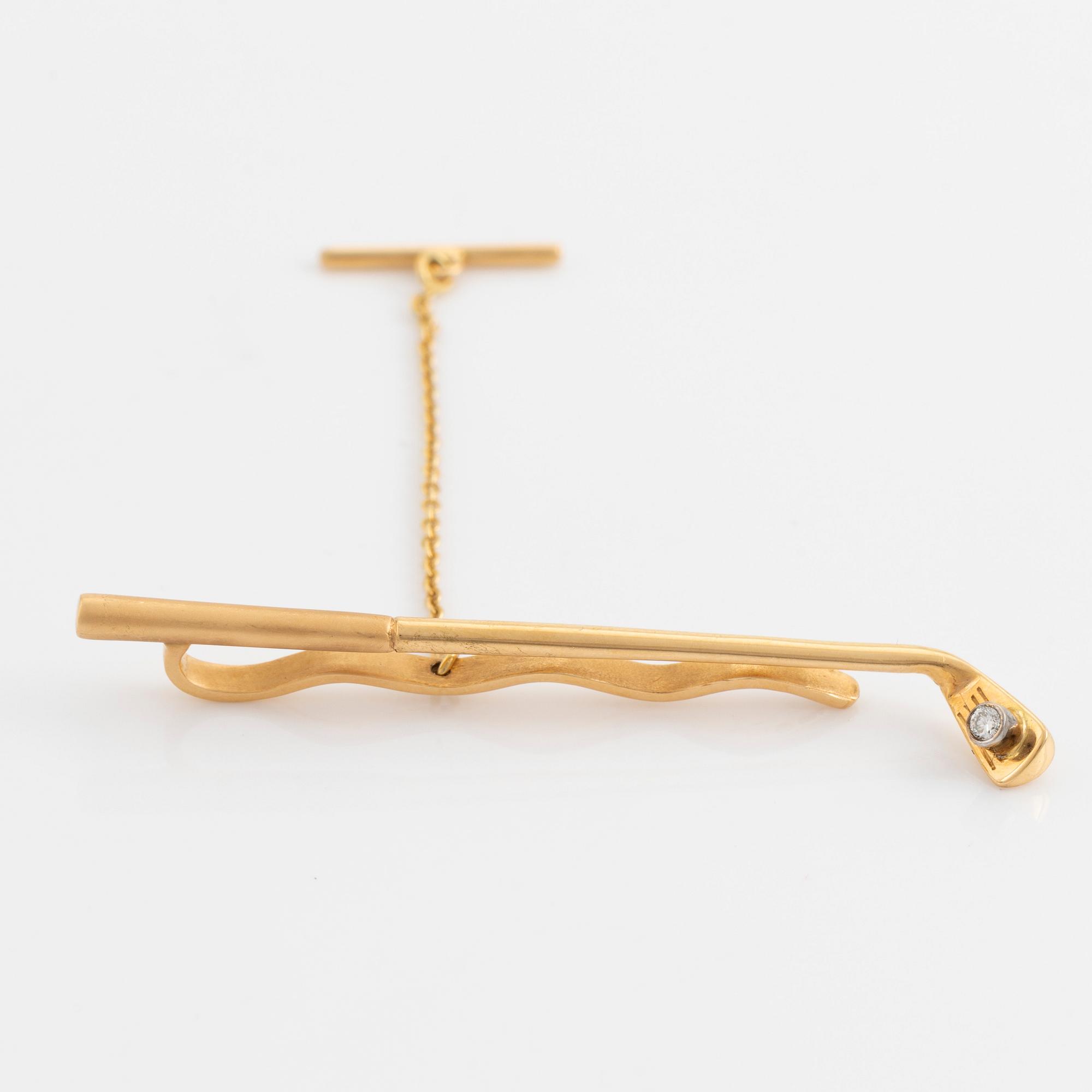 Slipsnål, 18K guld med briljantslipad diamant, i form av en golfklubba.