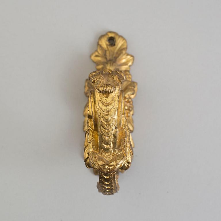 Four 19th century bronze tie-backs.