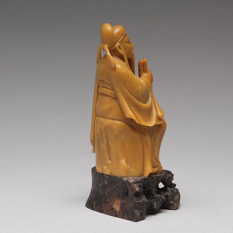 A soapstone figure of a seated scholar, late Qing dynasty, circa 1900.