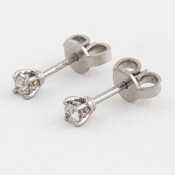 A pair of brilliant cut diamond earrings.