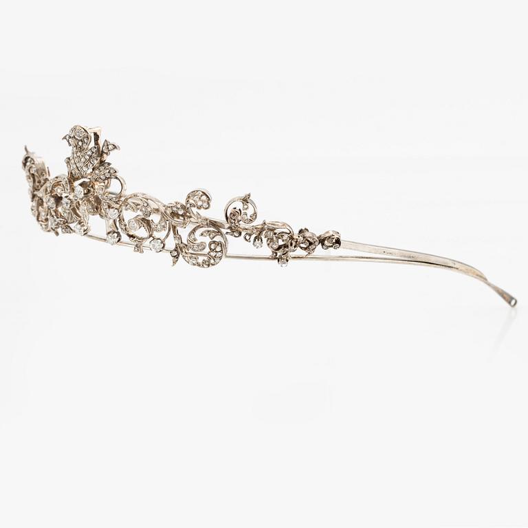 An 18K gold and silver tiara composed of scroll motifs set  with old- and rose-cut diamonds.