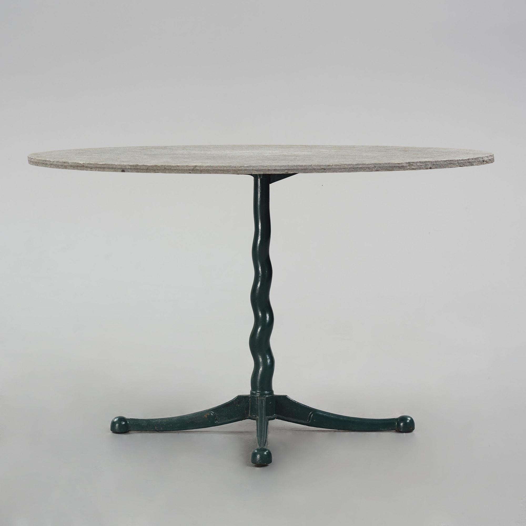 Josef Frank, attributed to, a cast iron table with granite top, Firma Svenskt Tenn, Sweden, 1930s-40s.