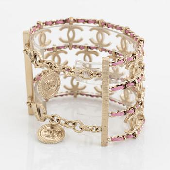 Chanel, a metal and leather bracelet.