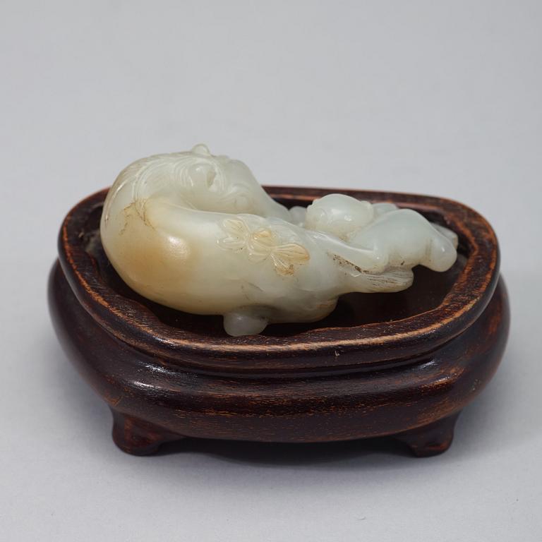 A chinese nephrite figure of a reclining horse and a monkey, early 20th Century.